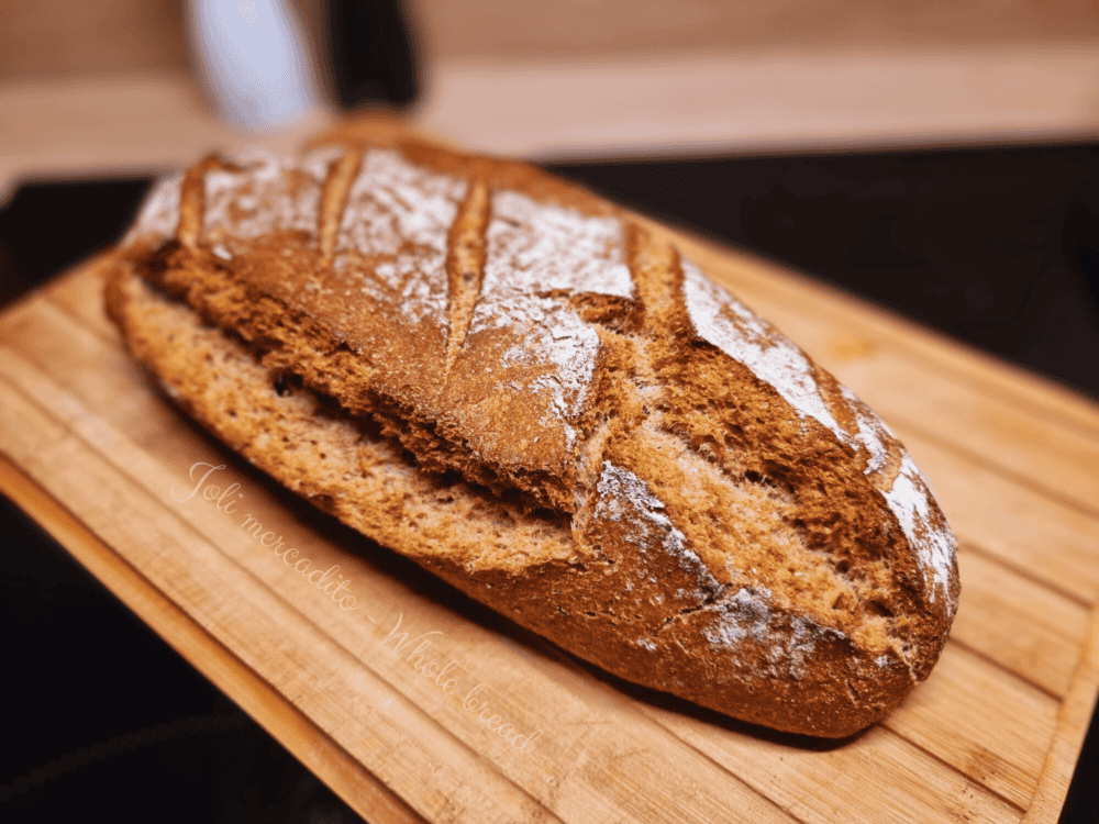 Homemade whole wheat bread (blé complet) with a golden-brown crust, soft interior, and a rustic, wholesome appearance, perfect for any meal.
